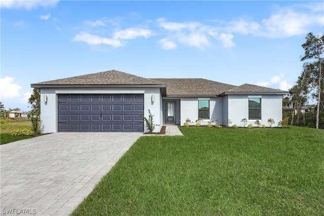 view of front of home with a front yard and a garage