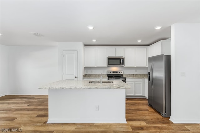 kitchen with light hardwood / wood-style flooring, white cabinetry, and appliances with stainless steel finishes