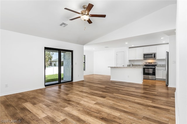 unfurnished living room with high vaulted ceiling, hardwood / wood-style floors, and ceiling fan