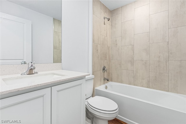 full bathroom featuring vanity, toilet, and tiled shower / bath combo