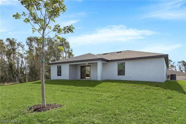 back of property featuring a yard and central AC unit