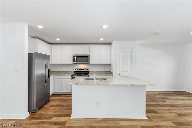 kitchen with sink, white cabinets, light wood-type flooring, and stainless steel appliances