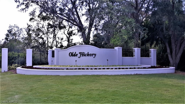 community / neighborhood sign with a yard