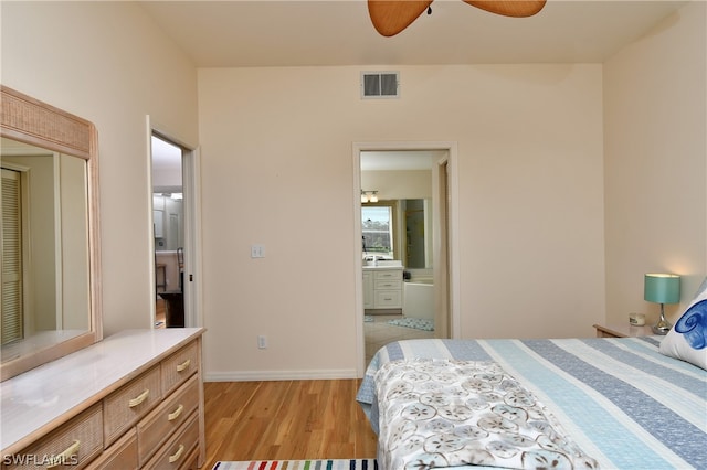 bedroom with ceiling fan, connected bathroom, and light hardwood / wood-style floors