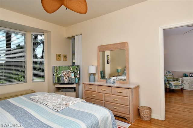 bedroom with ceiling fan and light wood-type flooring