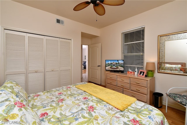 bedroom featuring hardwood / wood-style floors, a closet, and ceiling fan