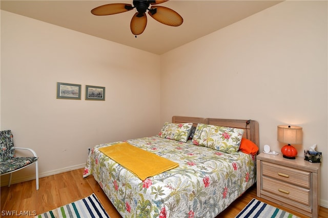 bedroom with ceiling fan and hardwood / wood-style floors