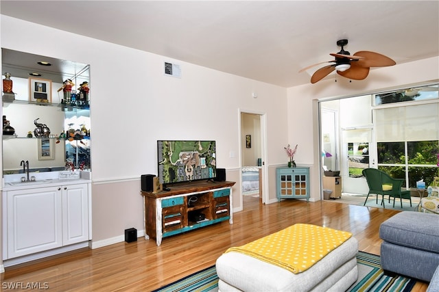 living room featuring sink, ceiling fan, and hardwood / wood-style floors