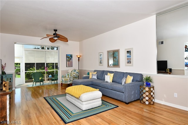 living room featuring ceiling fan and wood-type flooring