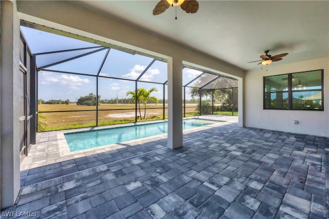 view of swimming pool with a patio, a lanai, and ceiling fan