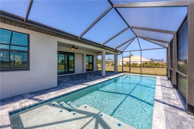 view of pool featuring a patio, a lanai, and ceiling fan