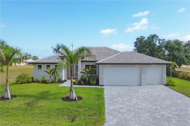 ranch-style house with a garage and a front lawn