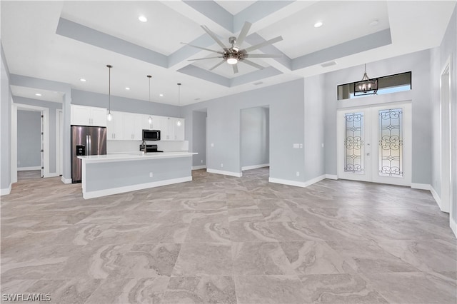 unfurnished living room with coffered ceiling, ceiling fan, french doors, and light tile flooring