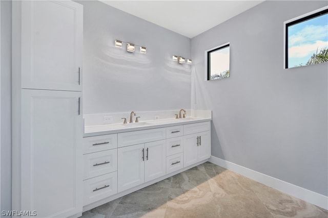 bathroom with tile floors and double vanity