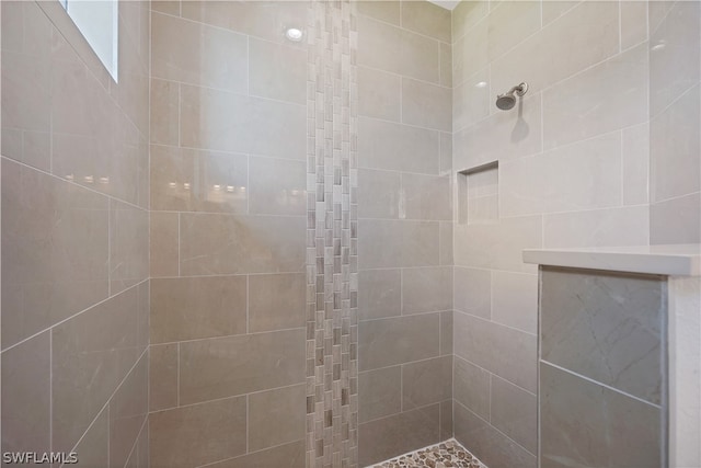 bathroom with tiled shower