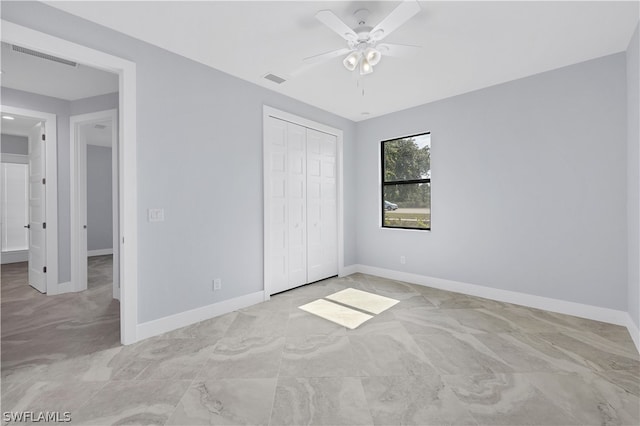 unfurnished bedroom with a closet, light tile flooring, and ceiling fan