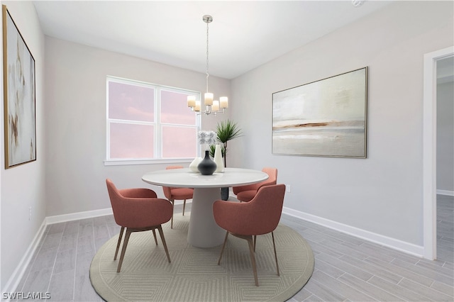 2206 NW 17th Pl, Cape Coral, FL 33993 - dining space with wood tiled floor, a chandelier, and baseboards