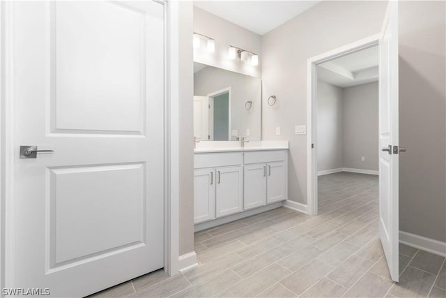 2206 NW 17th Pl, Cape Coral, FL 33993 - bathroom with vanity, wood finish floors, and baseboards