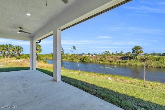 view of patio / terrace with a water view and ceiling fan