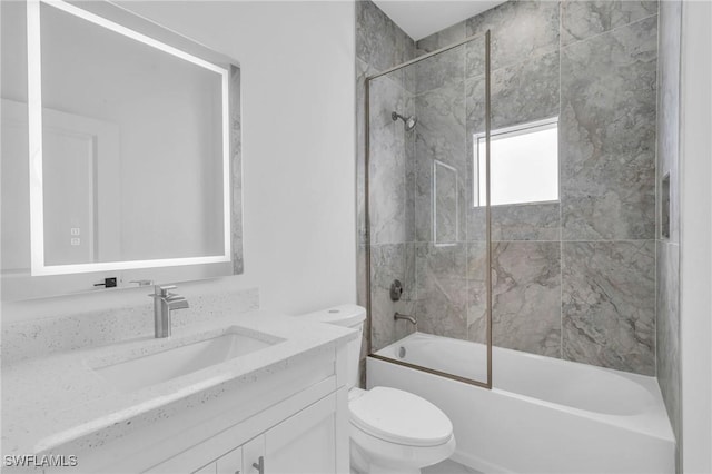 full bathroom with vanity, toilet, and shower / bath combination with glass door