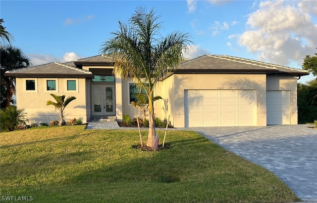 view of front of property with a front lawn, a garage, and french doors