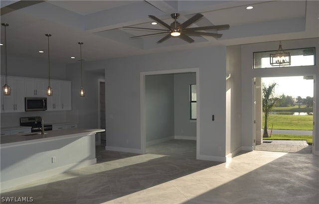 interior space featuring tile floors and ceiling fan with notable chandelier