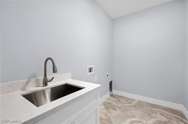 clothes washing area featuring cabinets, electric dryer hookup, washer hookup, sink, and light tile floors