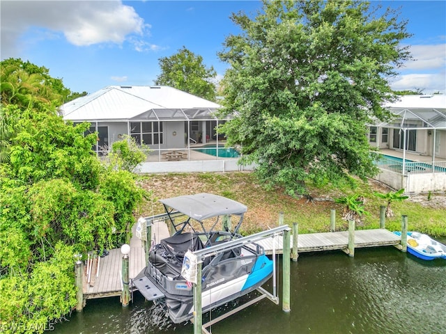 view of dock with a patio, a water view, and glass enclosure