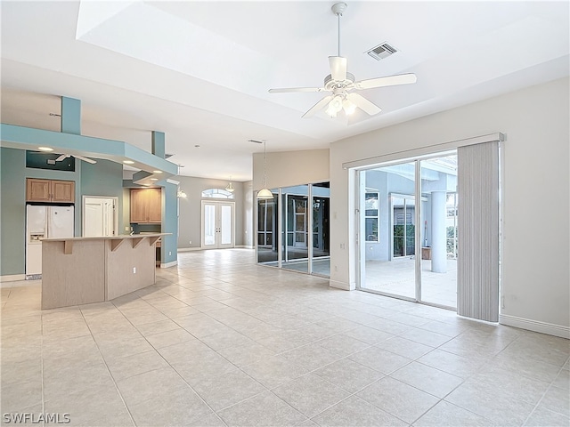 unfurnished living room featuring french doors, ceiling fan, and light tile patterned floors