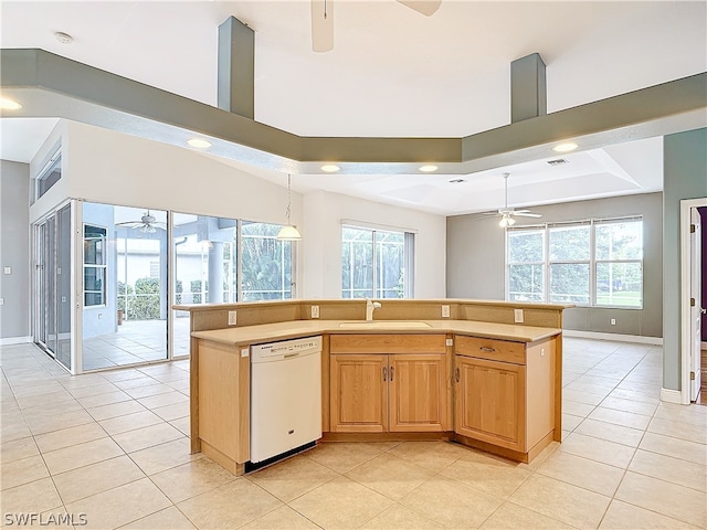 kitchen featuring sink, dishwasher, ceiling fan, and a raised ceiling