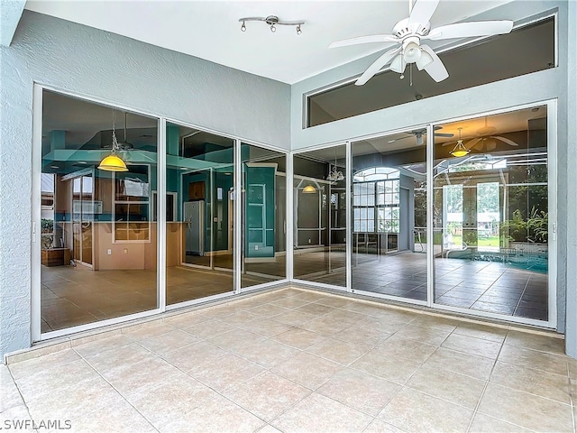 interior space featuring rail lighting, french doors, and ceiling fan