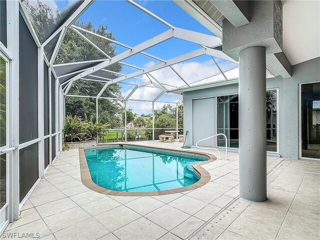 view of pool featuring a patio area and a lanai