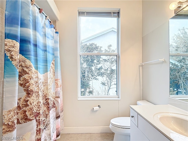 bathroom featuring vanity, tile patterned floors, and toilet