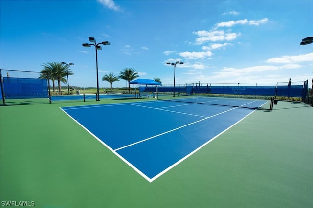 view of tennis court featuring fence