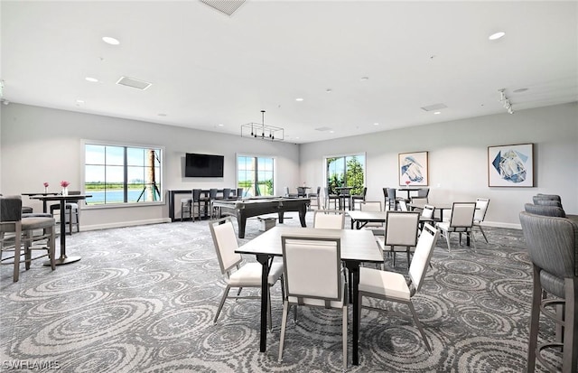 dining area featuring carpet, plenty of natural light, and baseboards