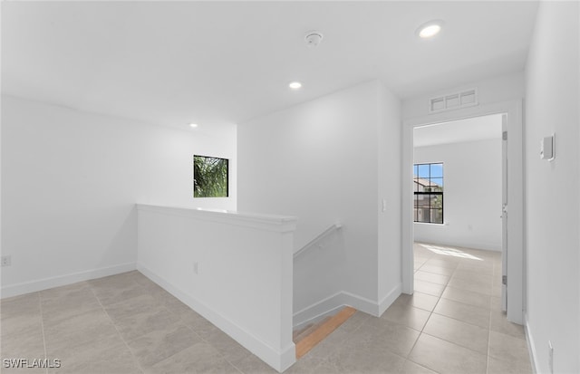 hall with light tile patterned floors