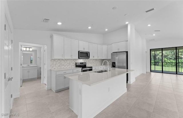 kitchen with visible vents, stainless steel appliances, a sink, and light countertops