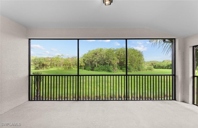 unfurnished sunroom with lofted ceiling