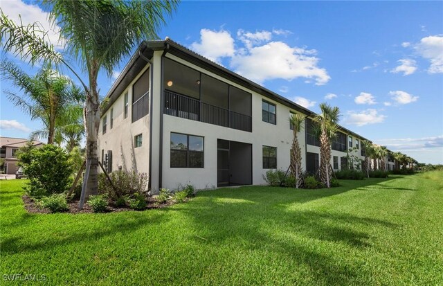 rear view of property featuring a yard