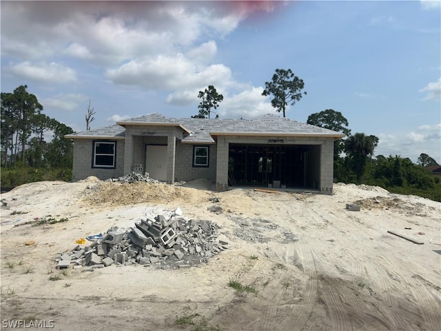 unfinished property featuring a garage