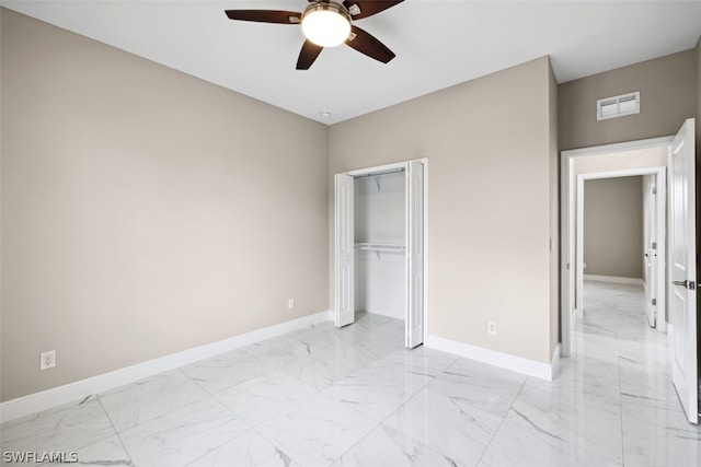 unfurnished bedroom with ceiling fan and a closet