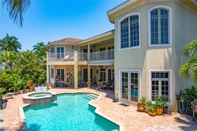 view of pool featuring a patio area and an in ground hot tub