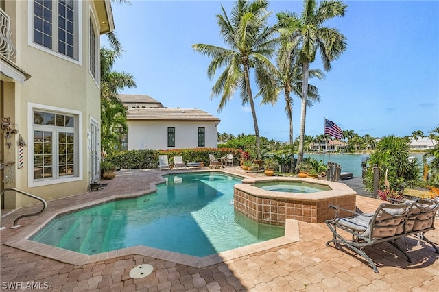 view of pool featuring a patio and an in ground hot tub