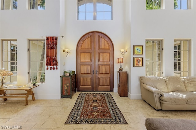 foyer with a high ceiling and tile flooring