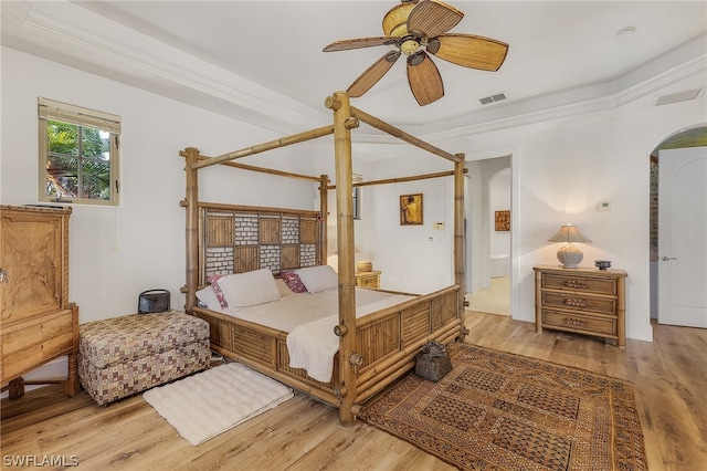 bedroom with crown molding, hardwood / wood-style flooring, and ceiling fan