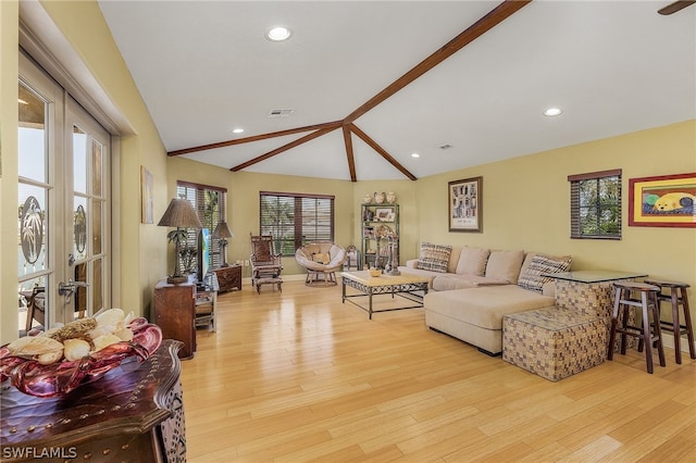 living room featuring lofted ceiling and light wood-type flooring