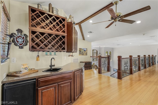 bar with ceiling fan, lofted ceiling with beams, light wood-type flooring, and sink