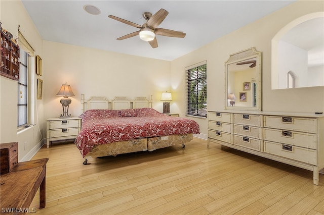 bedroom with light hardwood / wood-style floors and ceiling fan