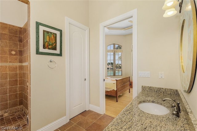 bathroom featuring tile floors, a raised ceiling, and vanity