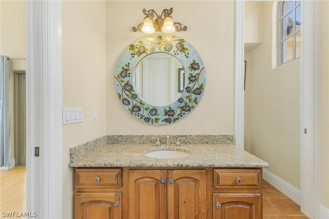 bathroom featuring hardwood / wood-style flooring and large vanity